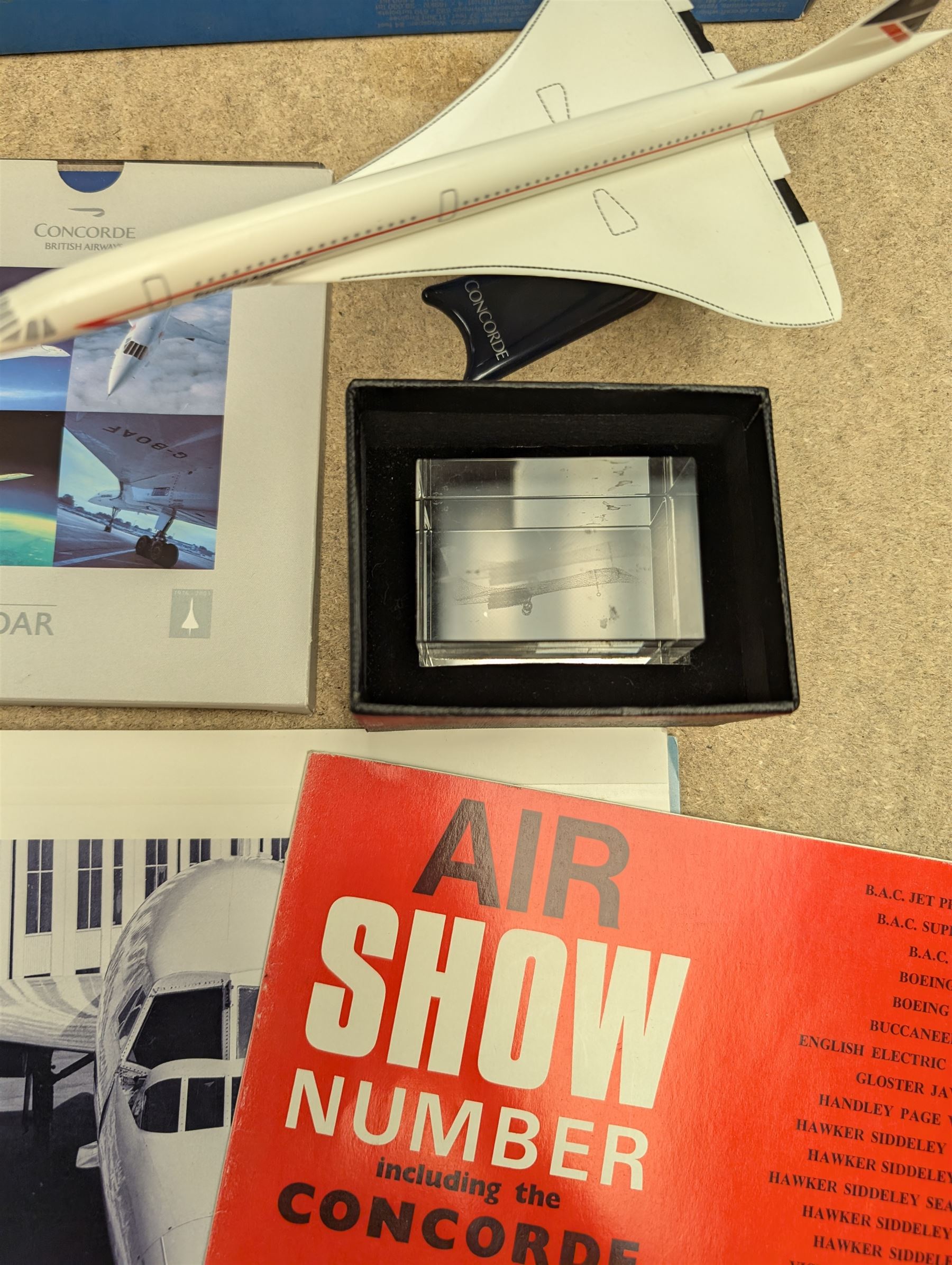 Collection of Concorde memorabilia, including paperweight, limited edition print, calendars, scale model, etc 