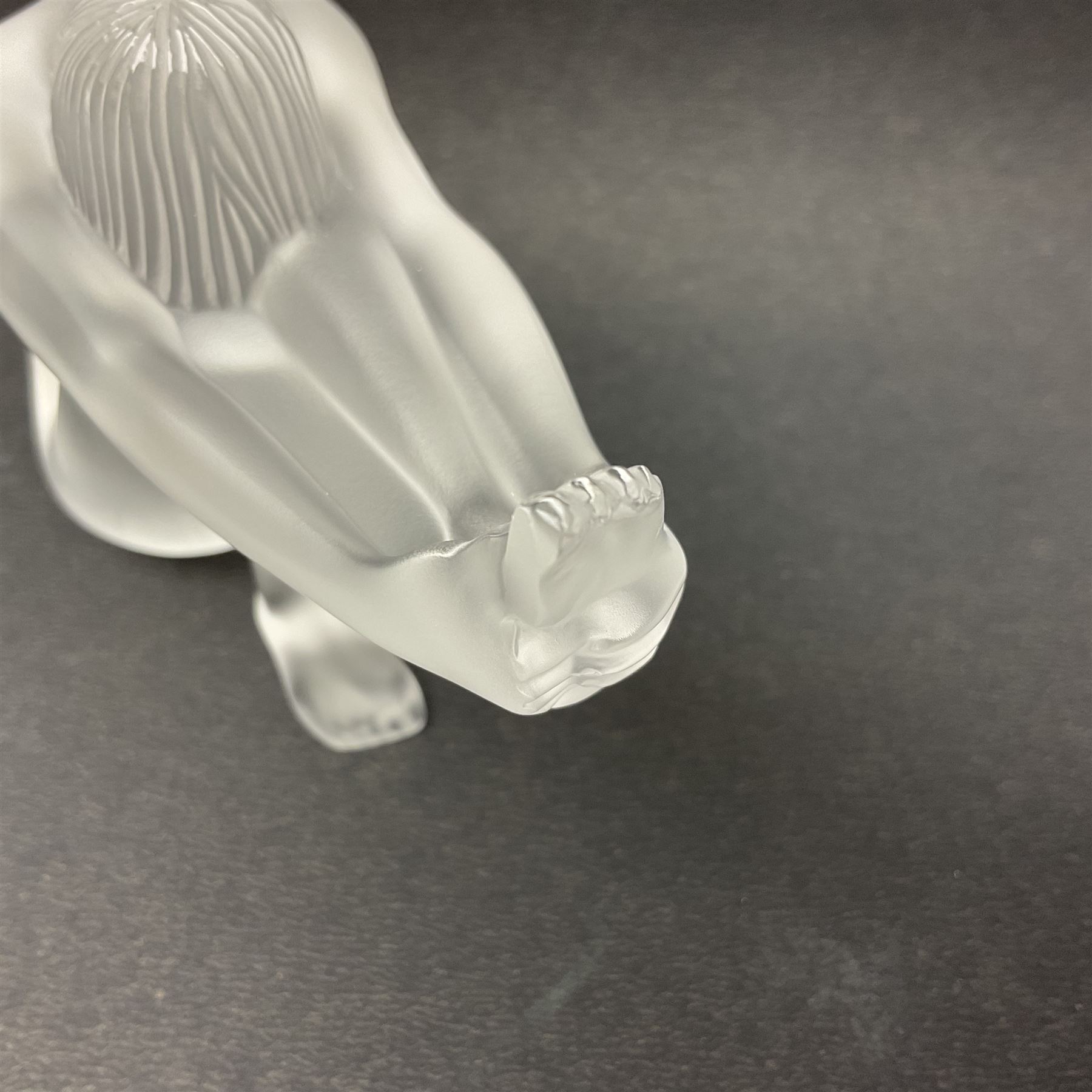 Lalique Nude Temptation, a frosted glass figure of a woman crouching with leg outstretched, in original box, H8cm