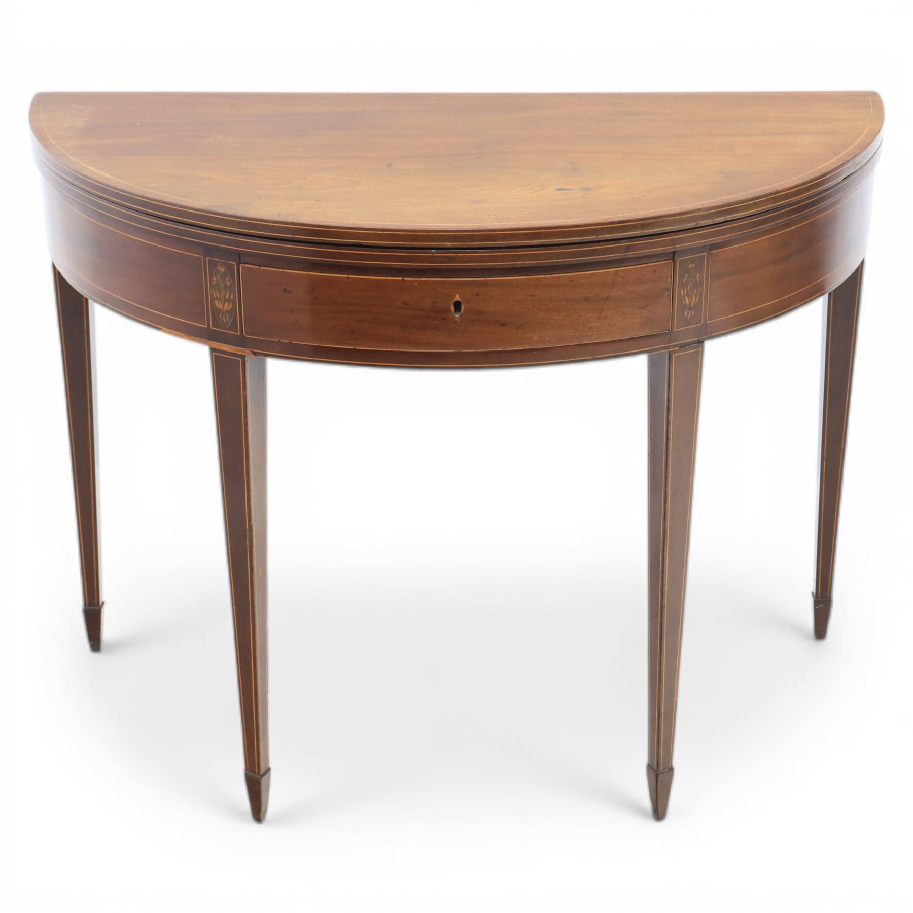 George III Scottish inlaid mahogany demi lune tea table, the curved fold over top opening to reveal a circular top with inlay to edge, above a frieze drawer with key, raised upon tapering inlaid legs with spade feet
