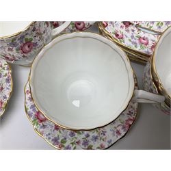 Windsor tea service for six decorated with blooming pink roses and purple flowers amongst foliage