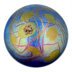 John Ditchfield for Glasform disc paperweight in iridescent blue with green lily trail and silver hallmarked frog to top, D13cm