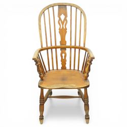 Set of two late 19th century elm and beech Windsor armchairs, each with hoop backs and turned spindles, shaped central splats, solid seats and turned supports united by H-stretchers