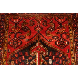 Persian Hamedan red ground rug, central medallion, repeating border, 207cm x 105cm  