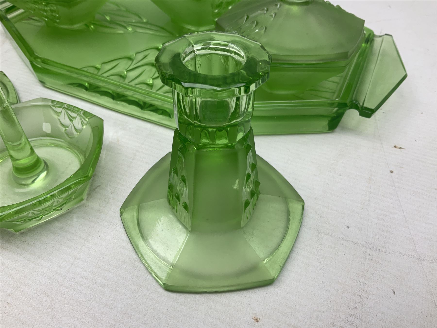 Czech uranium glass dressing table set, comprising twin handled tray, pair of candlesticks, three lidded jars and ring holder dish, and a blue Finnish Riihimäki glass, tray L35cm