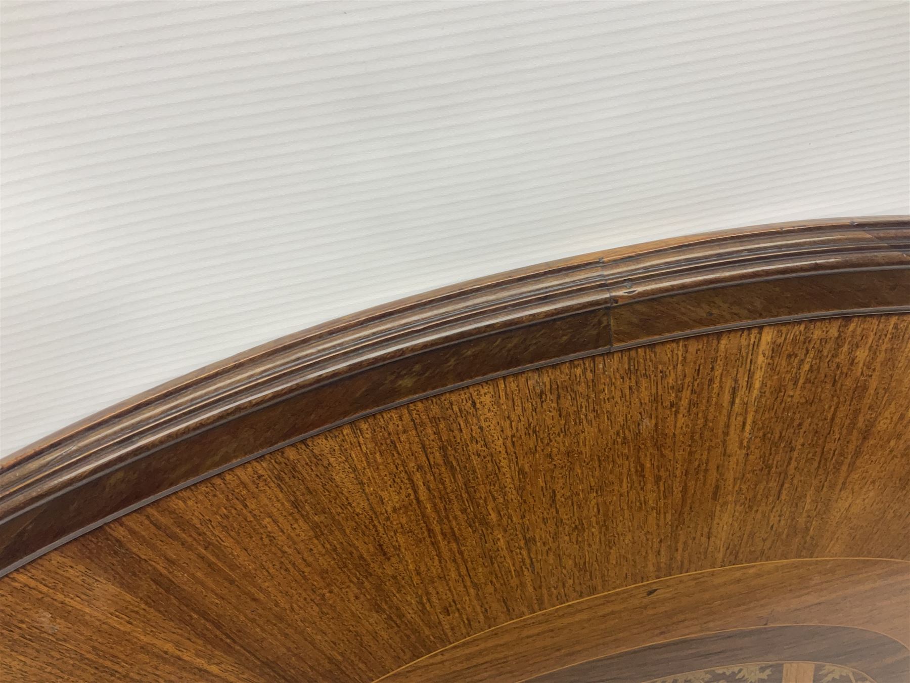 Late 19th/early 20th century mahogany and marquetry inlaid tray, of oval form with twin scrolled handles and moulded border, the central panel inlaid with figures seated at a table drinking tea, L99cm