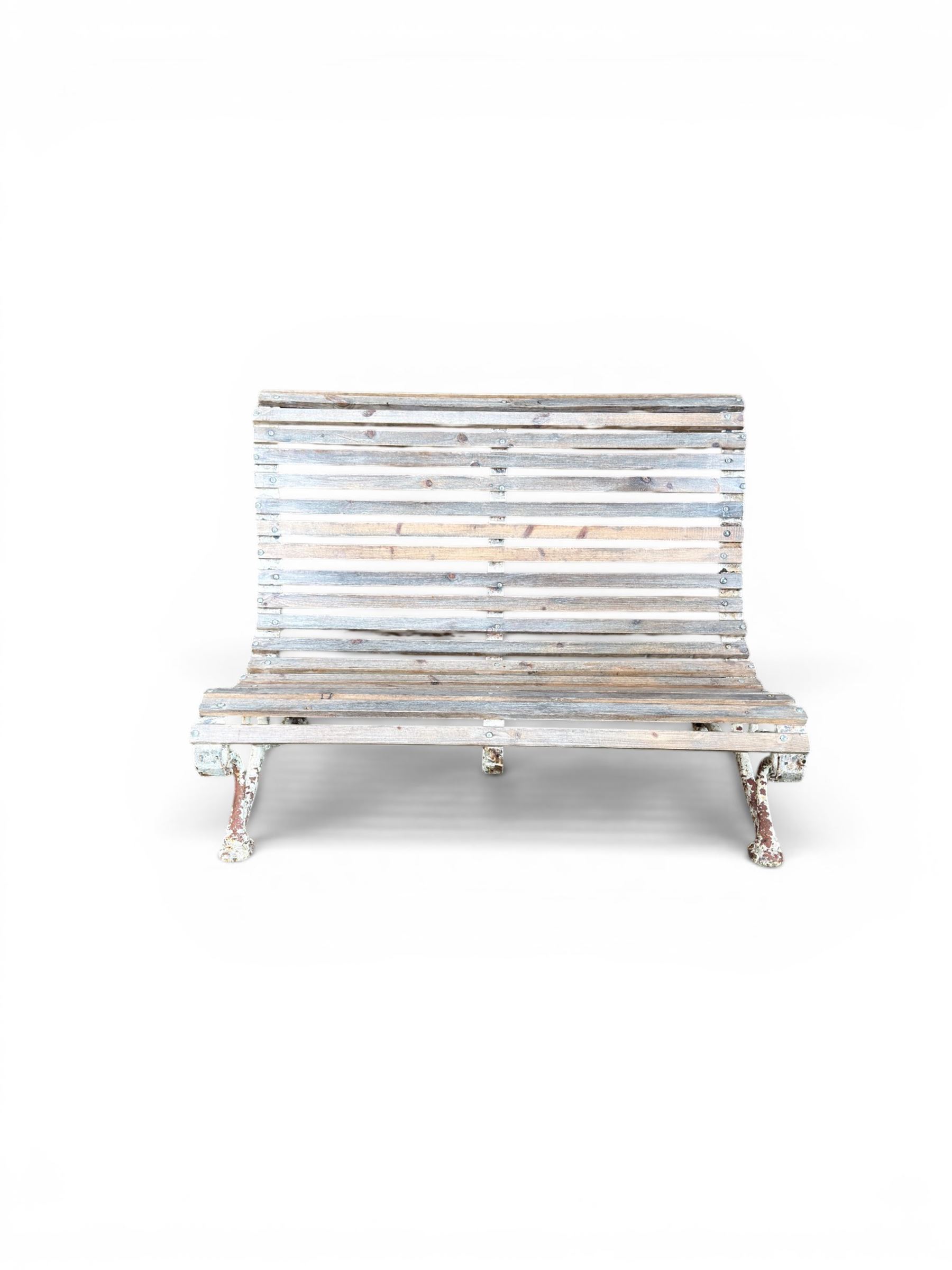 19th century cast iron and wood slatted garden bench, high scroll back form, low X shaped base, finished in distressed white paint