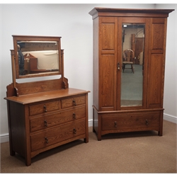  Arts & Crafts period panelled oak wardrobe, enclosed by single bevel edge glazed door, single drawer to base (W116cm, H191cm, D49cm), and a matching dressing chest, raised rectangular bevel edged mirror, two short and two long drawers (W108cm, H160cm, D47cm)  