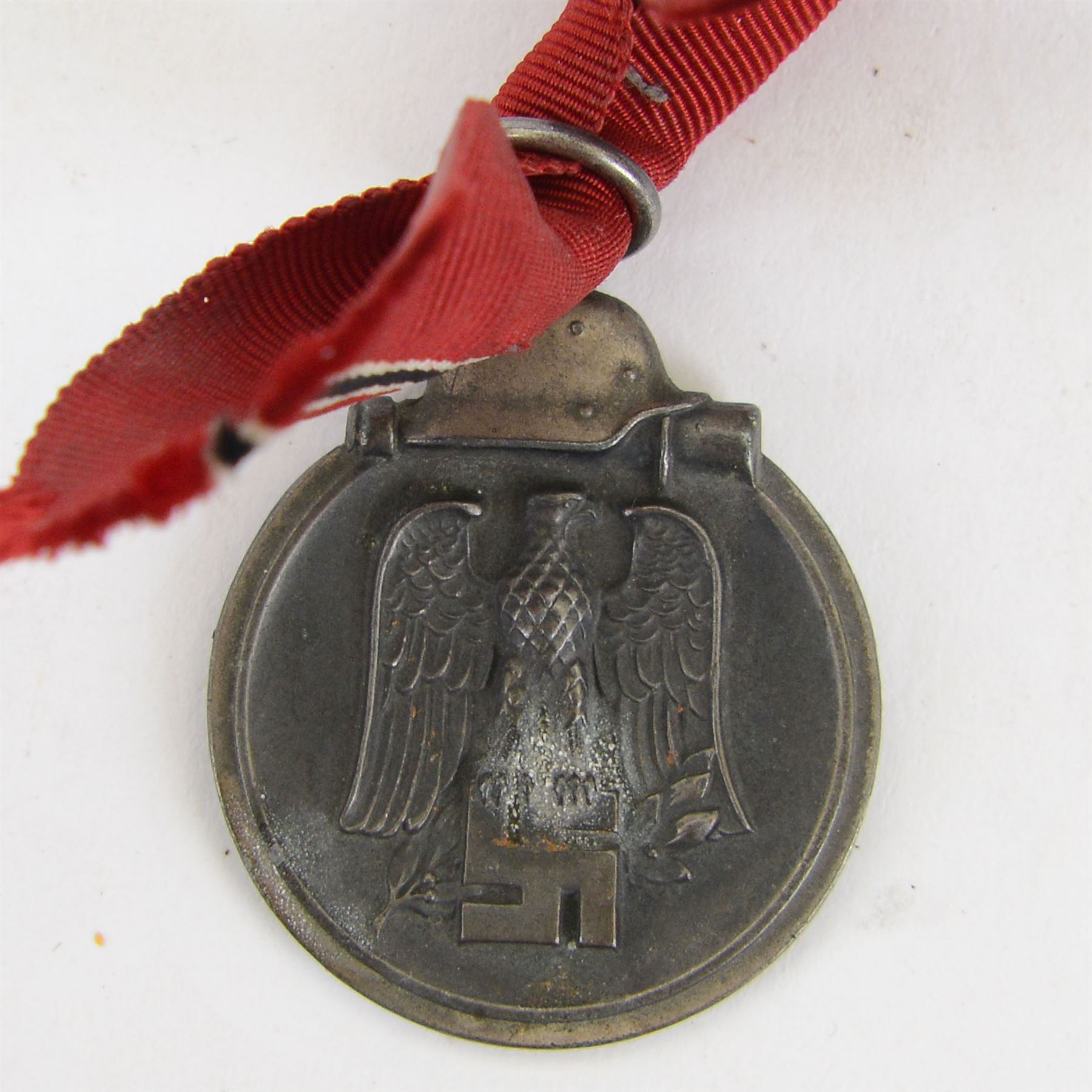 Third Reich SS officers cap insignia, machine-woven silver bullion SS Eagle, on black rectangle, together with German Eastern Front Medal, insignia H5cm, L7cm 