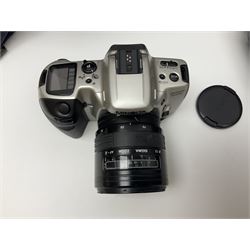 Four Minolta camera bodies, to include Dynax 500si, serial no. 94812651 with 'Signa Zoom 1;3.5-4.5 f=28-70mm' lens, Maxxum 300si, serial no. 97821665, with 'Tamron AF 80-210mm' lens and Dynax 300si, serial no 01603265'  with Minolta AF Power Zoom 35-80mm 1;4' lens, etc, together with Pantax MV1 camera bodies and other camera equipment 