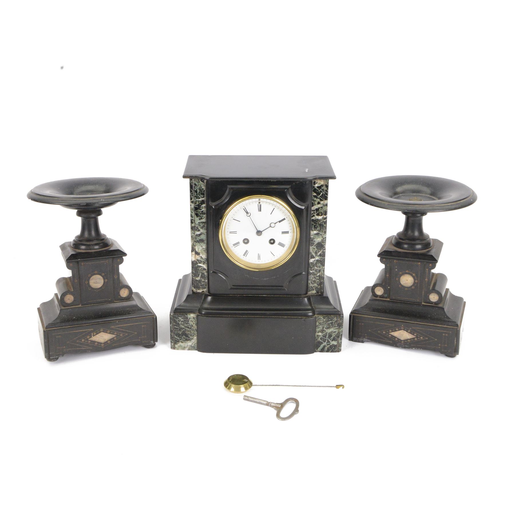 French-late 19th century Belgium slate mantle clock with a break-front case, flat pediment and deep moulded plinth, with recessed green and white variegated marble columns to the front, enamel dial with Roman numerals and steel moon hands, countwheel striking movement sounding the hours and half-hours on a bell. With key and pendulum. With an associated pair of 24cm high Tazzas..