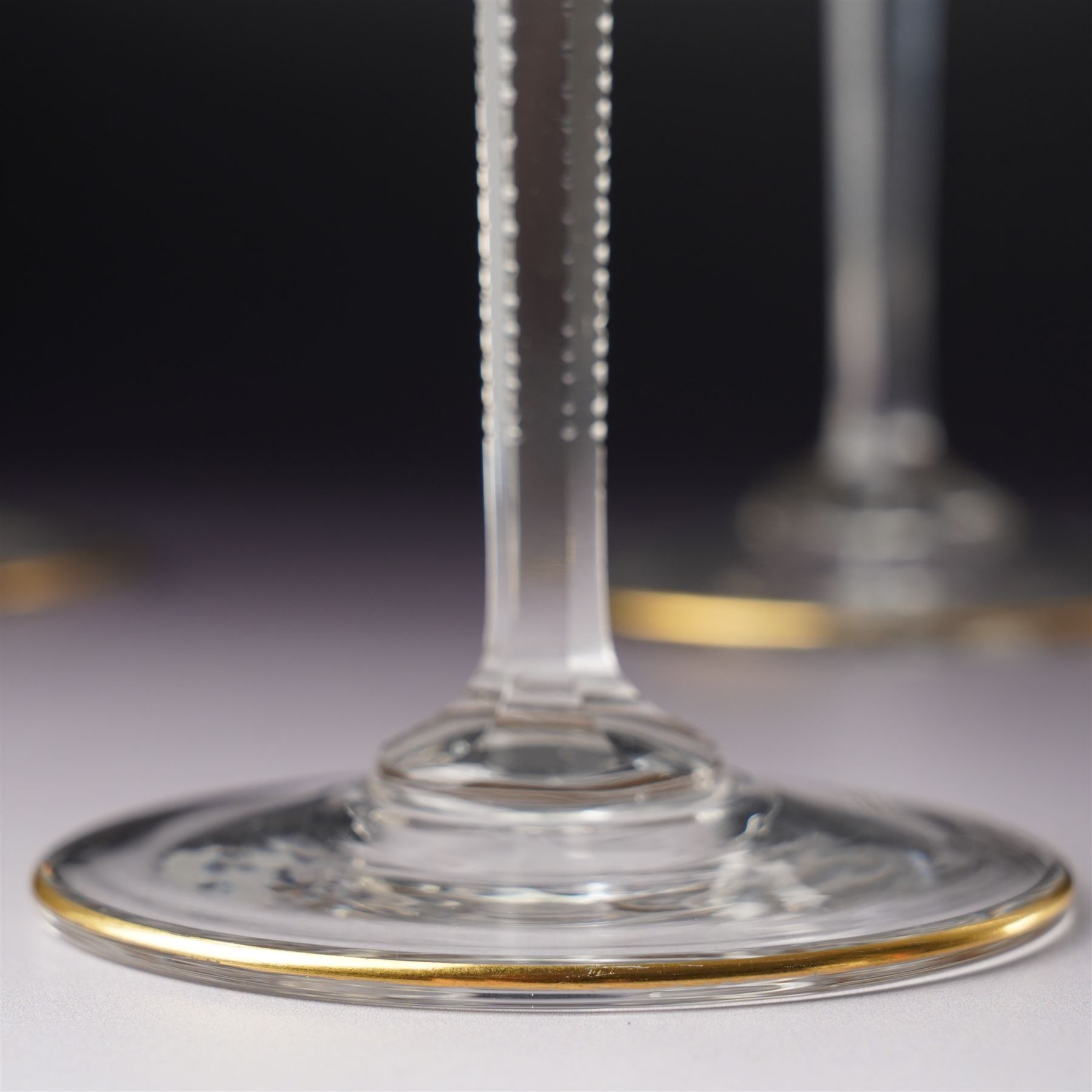 Set of six Wiener Werkstatte champagne coupe glasses, with gilt trimmed rim and foot, the faceted trumpet stem with toothed edges, H17cm 