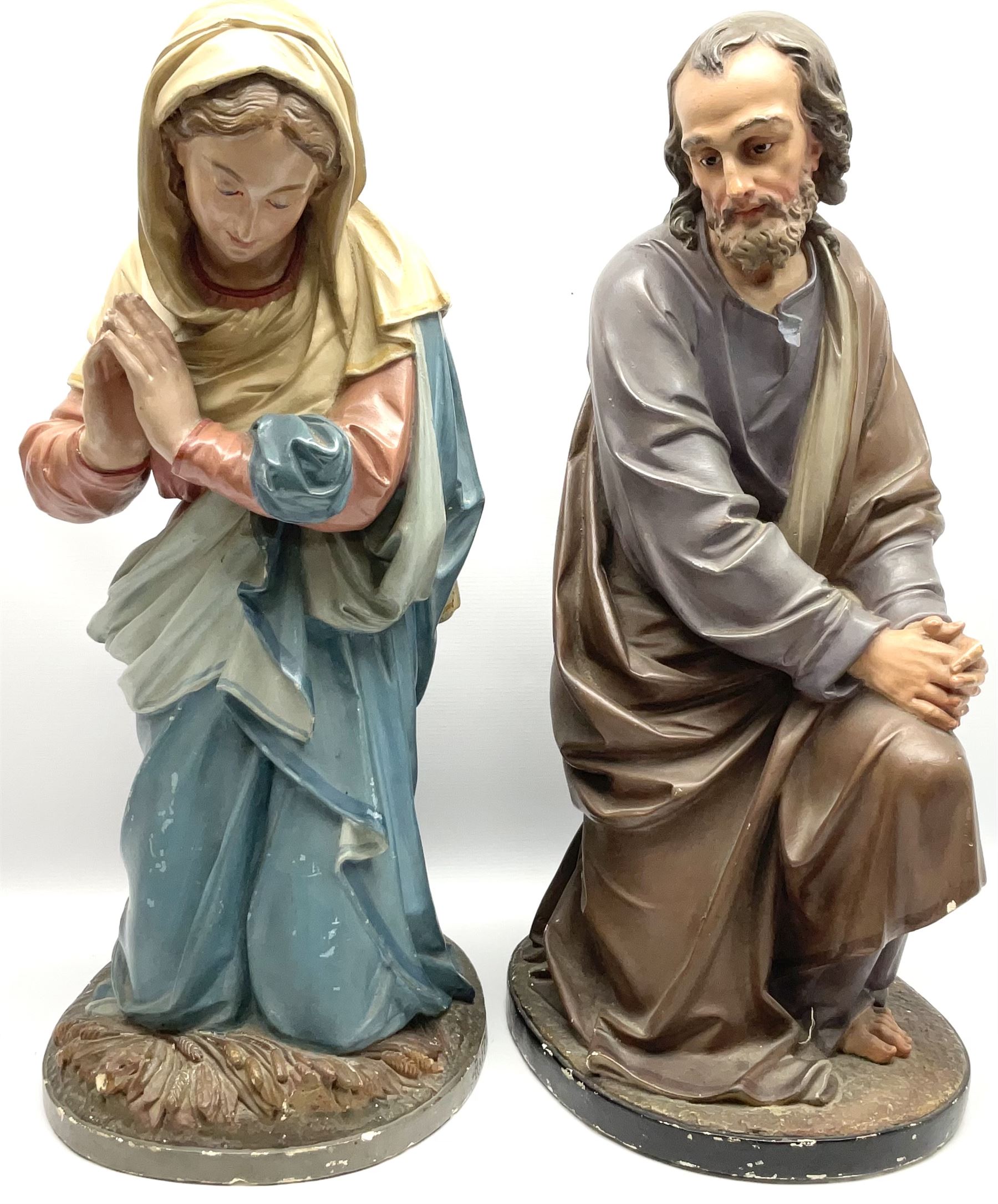 Two religious painted plaster figures of Mary and Joseph kneeling on oval plinths, with impressed mark 'Raffl et Cie Paris', H60cm 