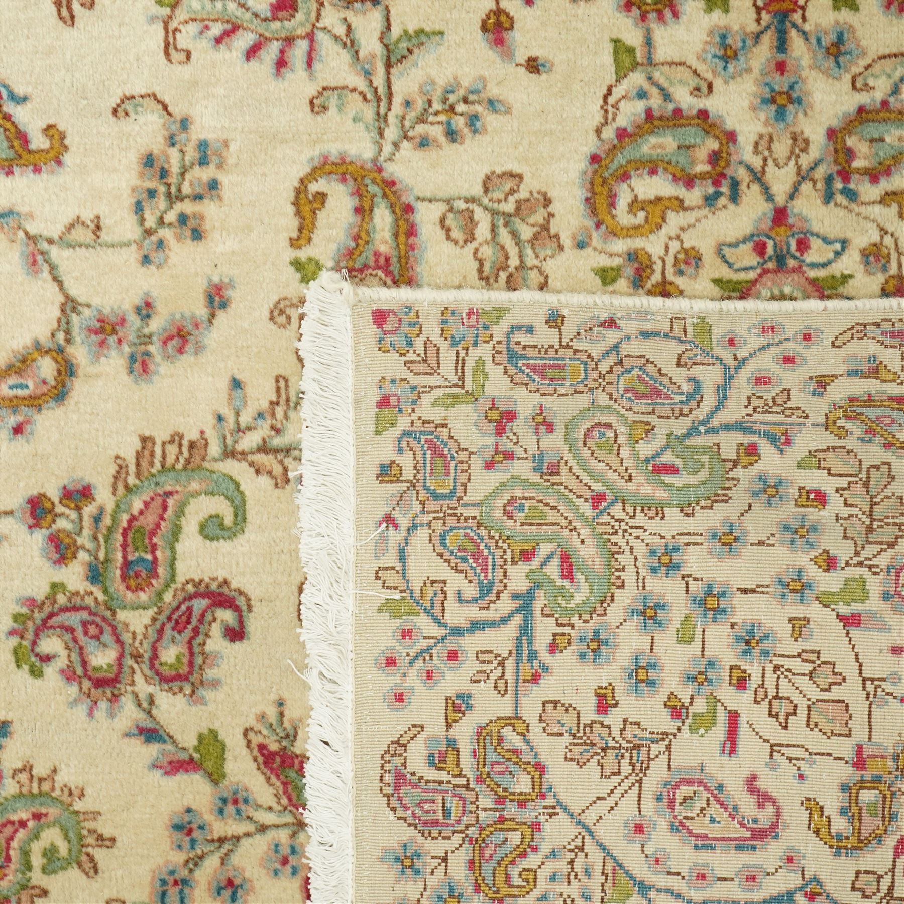 Persian Isfahan cream ground rug, overall floral design, sparse field decoration with trailing flower head and Boteh motifs, repeating floral pattern boarder with repeating motifs 