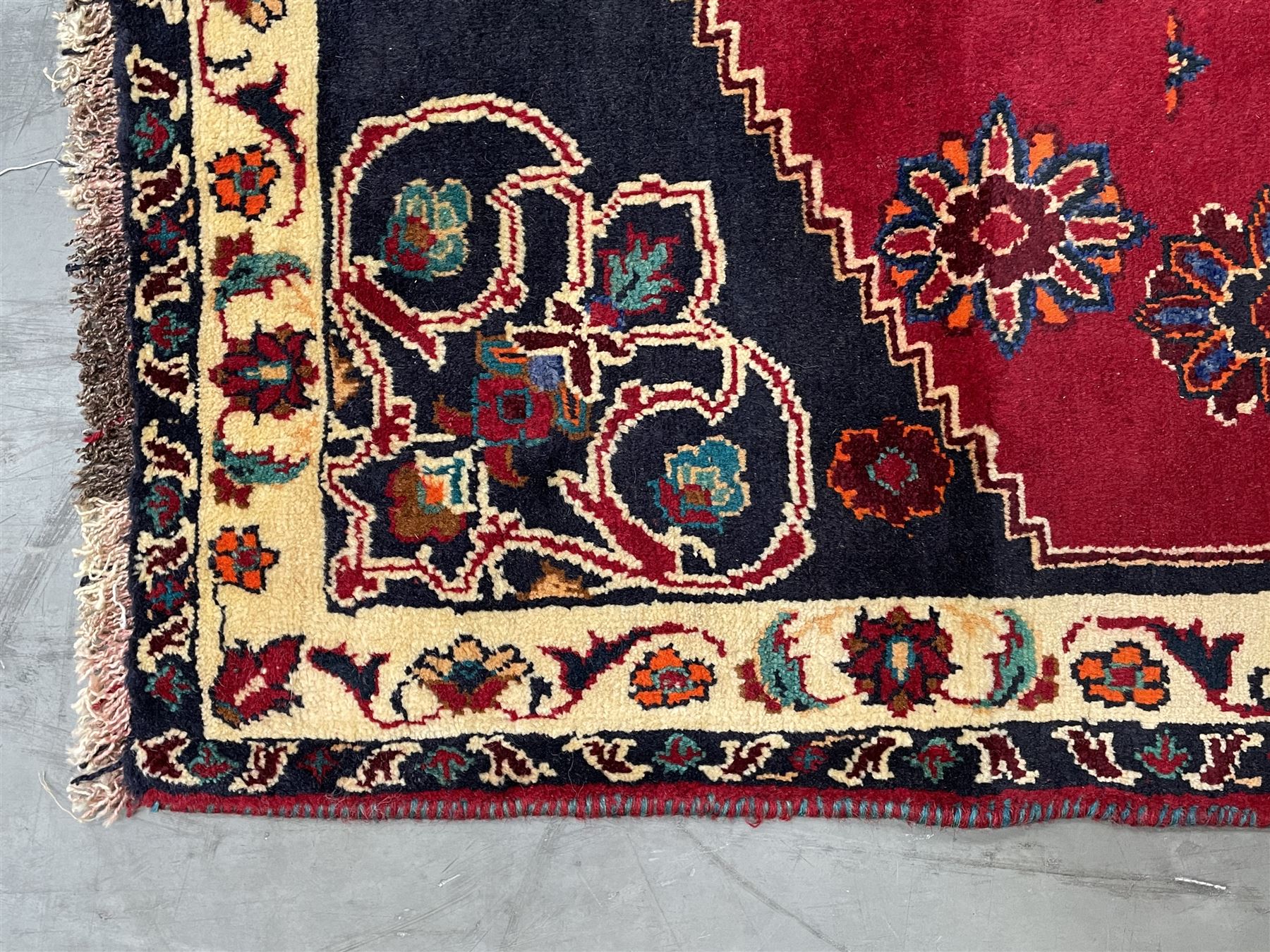 Persian rug, red ground field decorated with stylised flower heads and bird motifs, floral scrolling border
