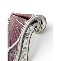 Large late Victorian cast iron garden bench, serpentine form with scroll back and seat, slatted with mahogany stained Sapele