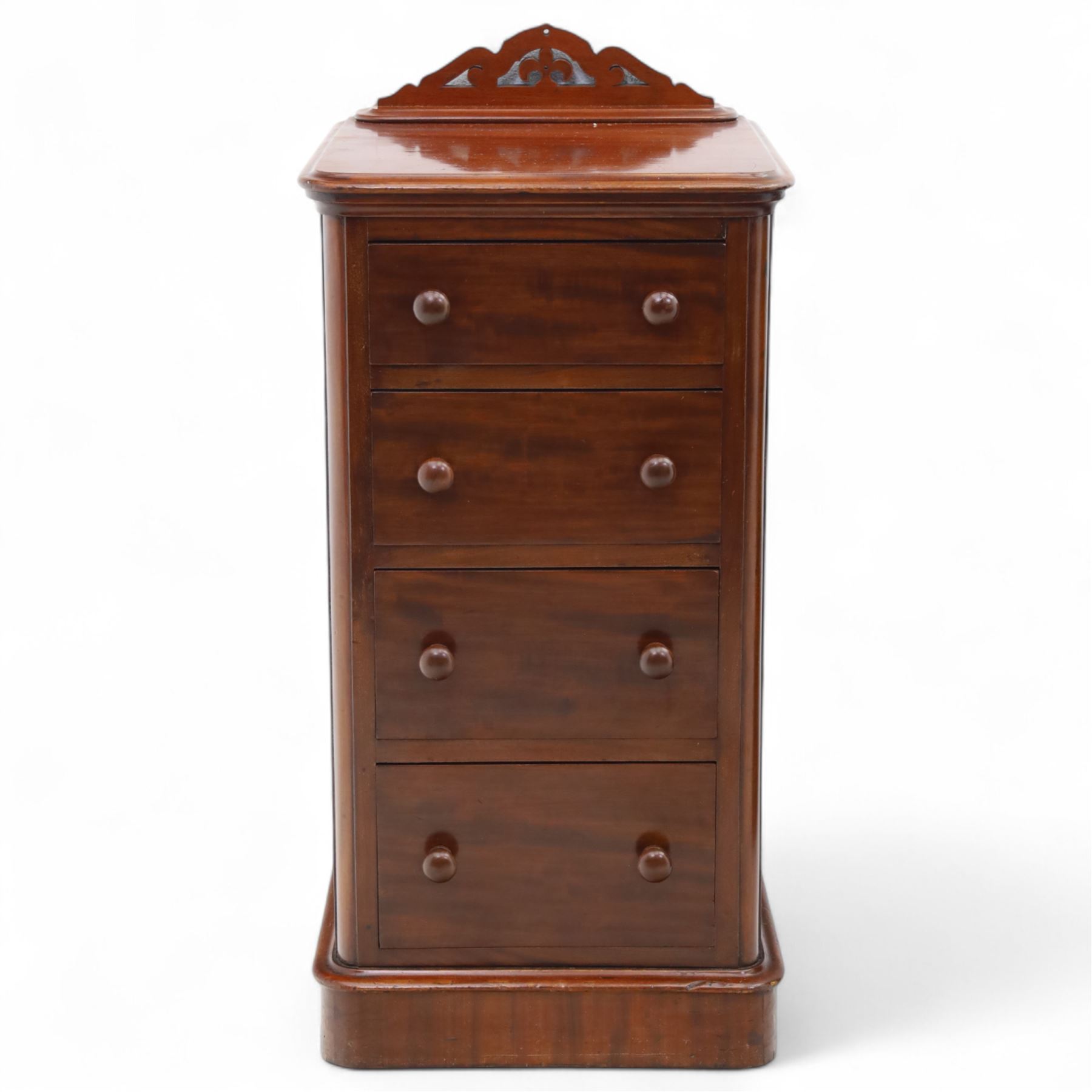 Pair of tall Victorian mahogany bedside chests, of narrow upright form, rectangular top with moulded edge, the back with raised pierced fretwork gallery, above four graduated drawers with knob handles, raised on a plinth base 