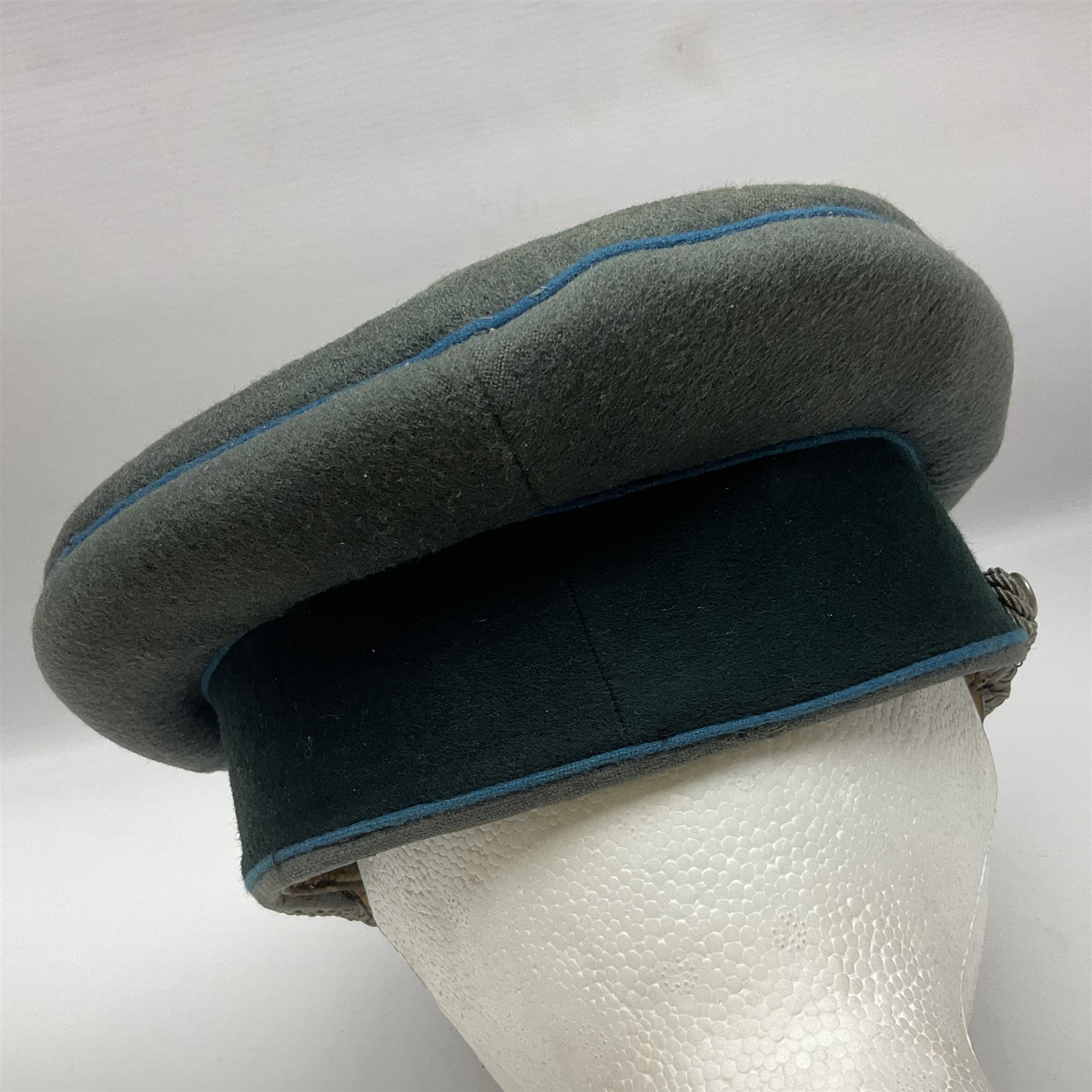 WW2 German Infantry Officer's visor cap with cloth insignia; labelled and stamped Offizier Kleiderkasse Berlin and Erel Stirnschutz