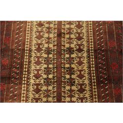 Two hand-knotted rugs, comprising Persian runner and Turkoman prayer rug, Persian hand-knotted runner, red and dark navy ground with four diamond medallions and geometric motifs, enclosed by multicoloured geometric border, striped kilim ends with fringes, H244cm, W58cm; Turkoman hand-knotted prayer rug, ivory mihrab field decorated with repeating stylised geometric motifs, enclosed by multiple geometric borders in madder red and brown, with fringed ends, H150cm, W93cm