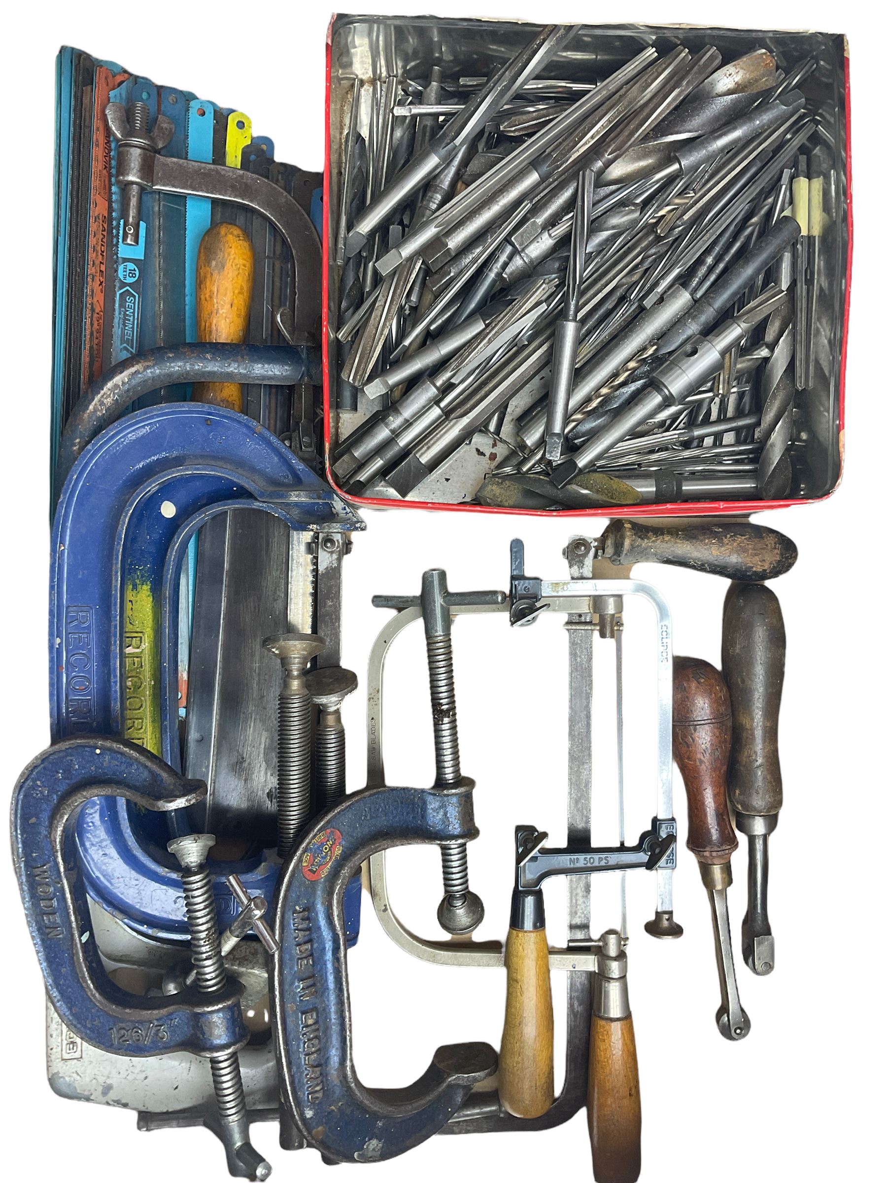 Assortment of hacksaw blades, various different sized Record G clamps, lathe reamers and various wood saws, piercing saw, fret saw and hack saws, with two hand knurling tools.