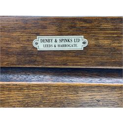 20th century carved oak court cupboard, s-scroll carved frieze over panelled cupboard door carved with arch, lobe and scroll carved cup and cover supports, fitted with three drawers and three cupboards below