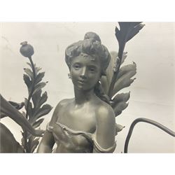 Pair of Art Nouveau style spelter figural table lamps, each mounted on rouge marble effect circular bases, with toleware flower heads and leafy decoration surrounding a female figure, H90cm