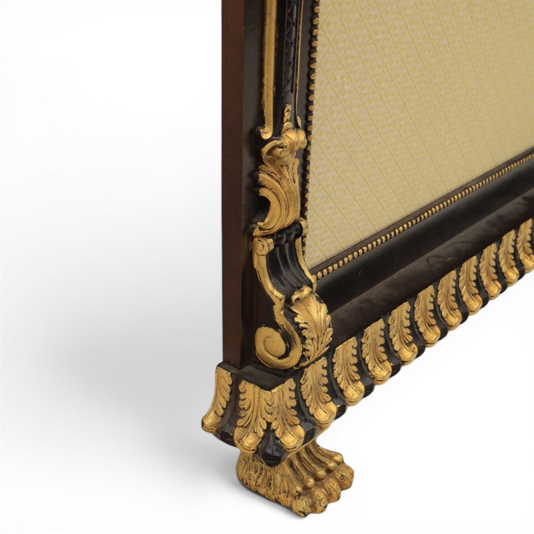 Empire design ebonised and parcel gilt hall stand, projecting moulded cornice with bead and reel border, upper rail fitted with three turned hat and coat pegs, central cream upholstered panel within beaded slip, flanked by scrolled uprights with gilt foliate and anthemion mounts, lower acanthus leaf apron, on paw feet