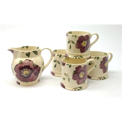 Four Emma Bridgewater mugs, together with a matching jug, each decorated with purple flowers upon a cream ground, mugs H7cm, jug H10cm. 
