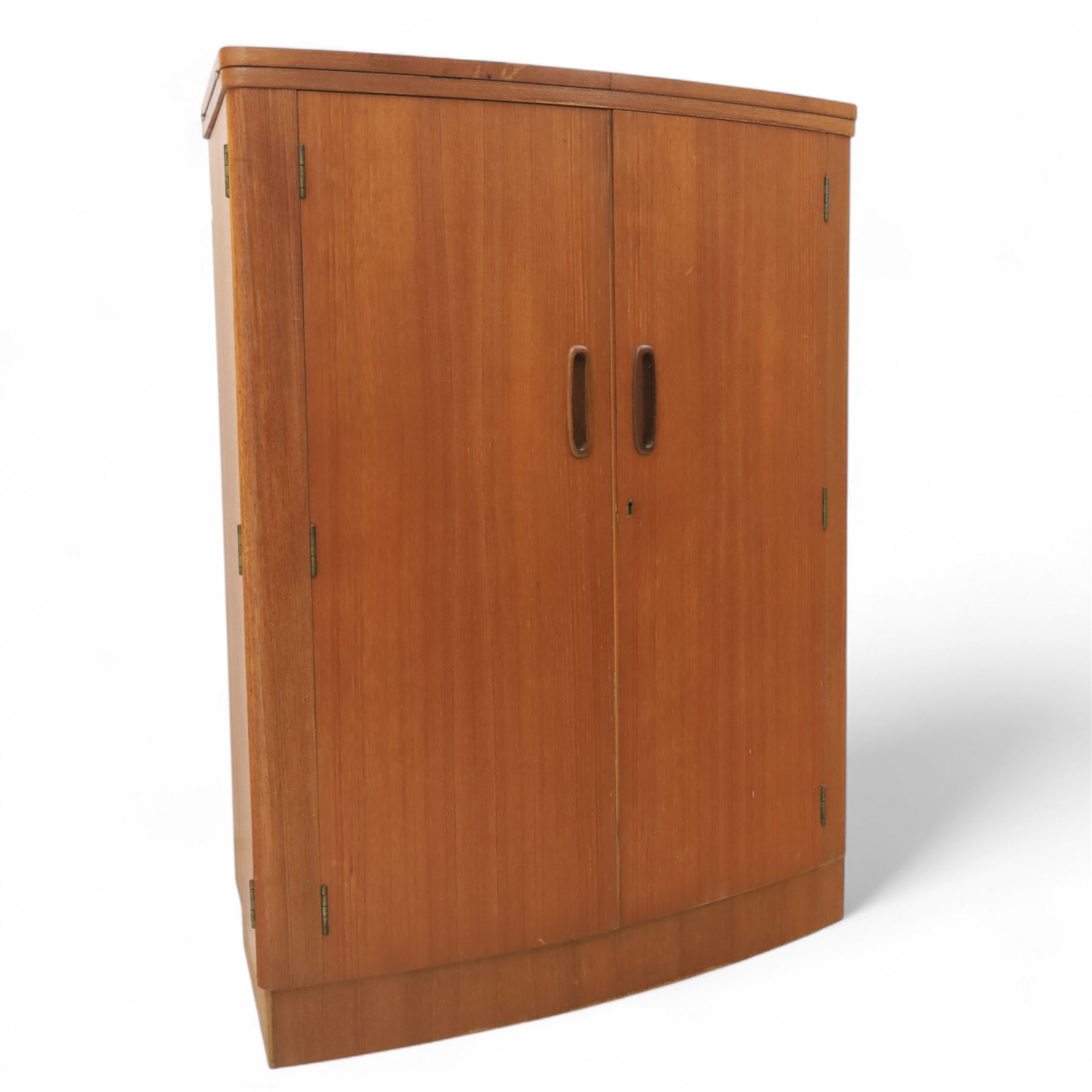 Turnbridge of London - Mid 20th century teak cocktail cabinet, with fold out top extending to 160cm, with twin doors revealing a shelved interior, the back with sliding glazed doors, raised on a recessed plinth base with castors
