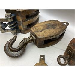 Five ship pulleys comprising two wooden block double with stiff swivel hook, wooden  with stiff swivel hook, and two more examples, largest example L60cm