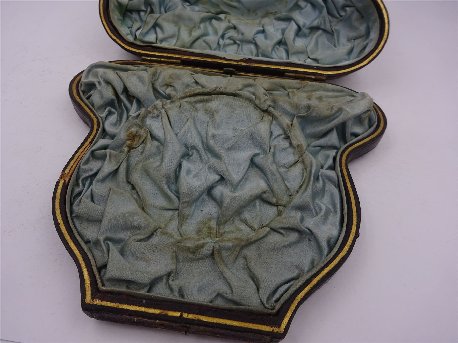 Victorian silver bowl, with embossed floral decoration and beaded rim, gilt interior and two applied shield cartouches, upon stepped circular foot, with a silver apostle spoon, with gilt bowl, both hallmarked George Unite, Birmingham 1883, bowl H5.5cm, within fitted tooled leather, silk lined case