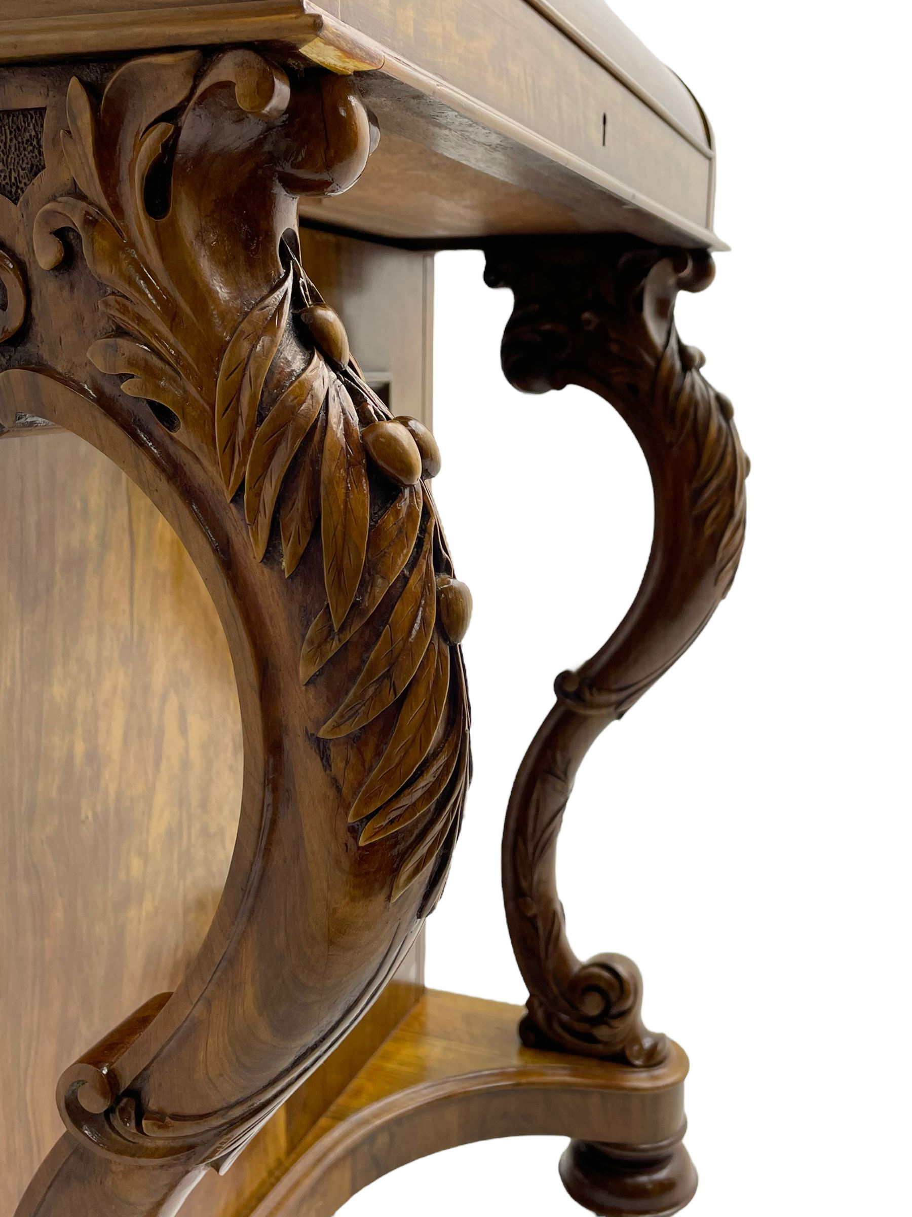 Fine and unusual 19th century olivewood piano top davenport, raised shaped back carved with olive branches and olives, the top hinges to reveal lidded and correspondence compartments, the piano lid enclosing sliding top with hinged and adjustable writing surface with leather inset, right-hand panelled door enclosing four drawers, olive branch and scroll carved cabriole front supports on moulded and shaped platform, turned cup feet with recessed castors 