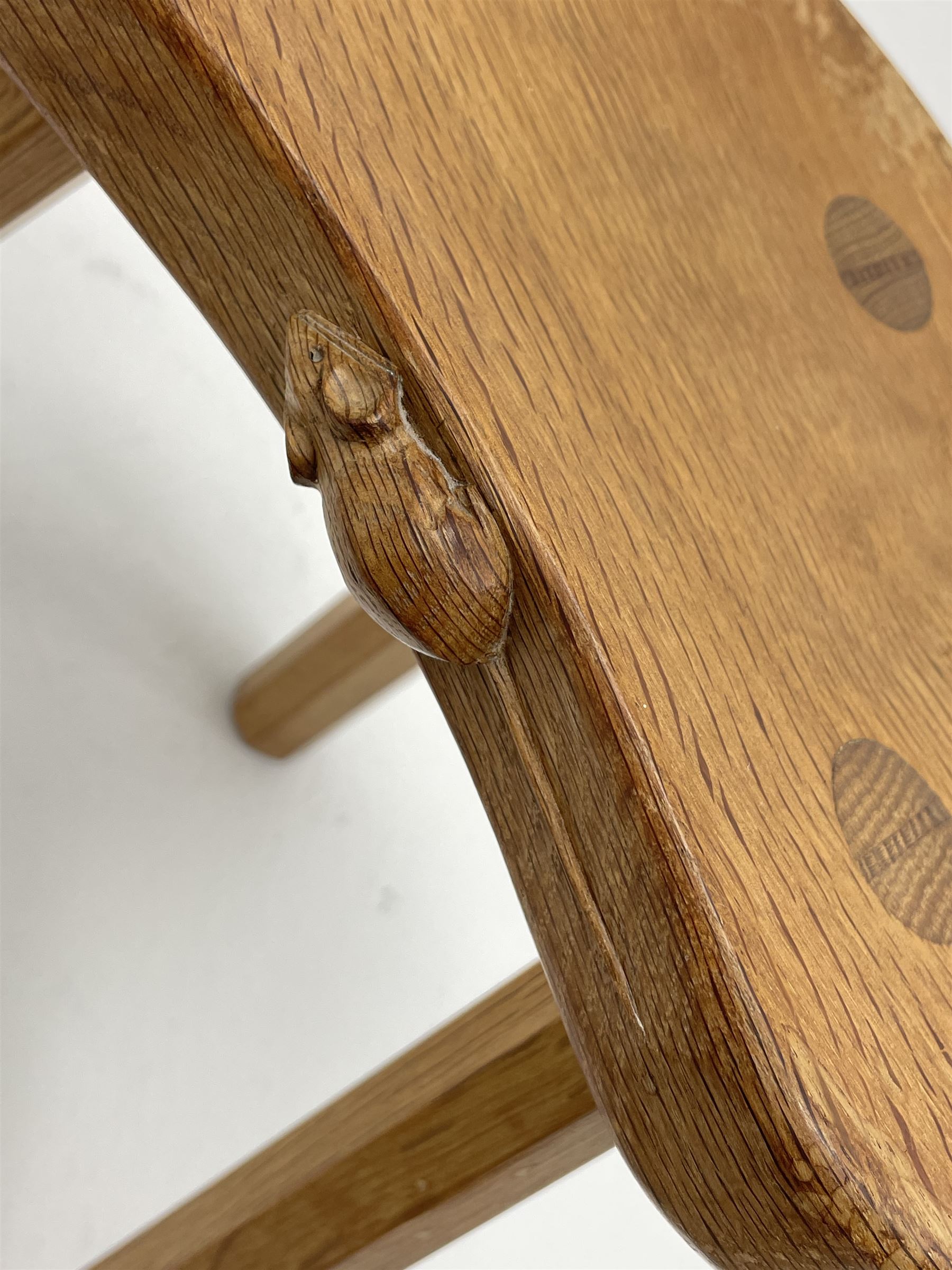 'Mouseman' oak three legged stool with dished kidney shaped seat, tapered octagonal supports, with carved mouse signature, by Robert Thompson of Kilburn 