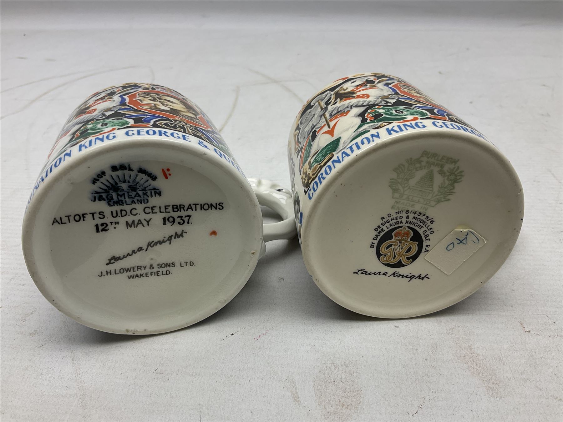 Two Dame Laura Knight coronation mugs for King George VI and Queen Elizabeth, comprising a Burleigh Ware example and a J&G Meakin example, each with a lion moulded handle and printed marks beneath, H8cm