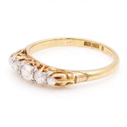Early 20th century gold diamond ring, set with five graduating old cut diamonds, with scroll design gallery, stamped 18ct, total diamond weight approx 0.30 carat