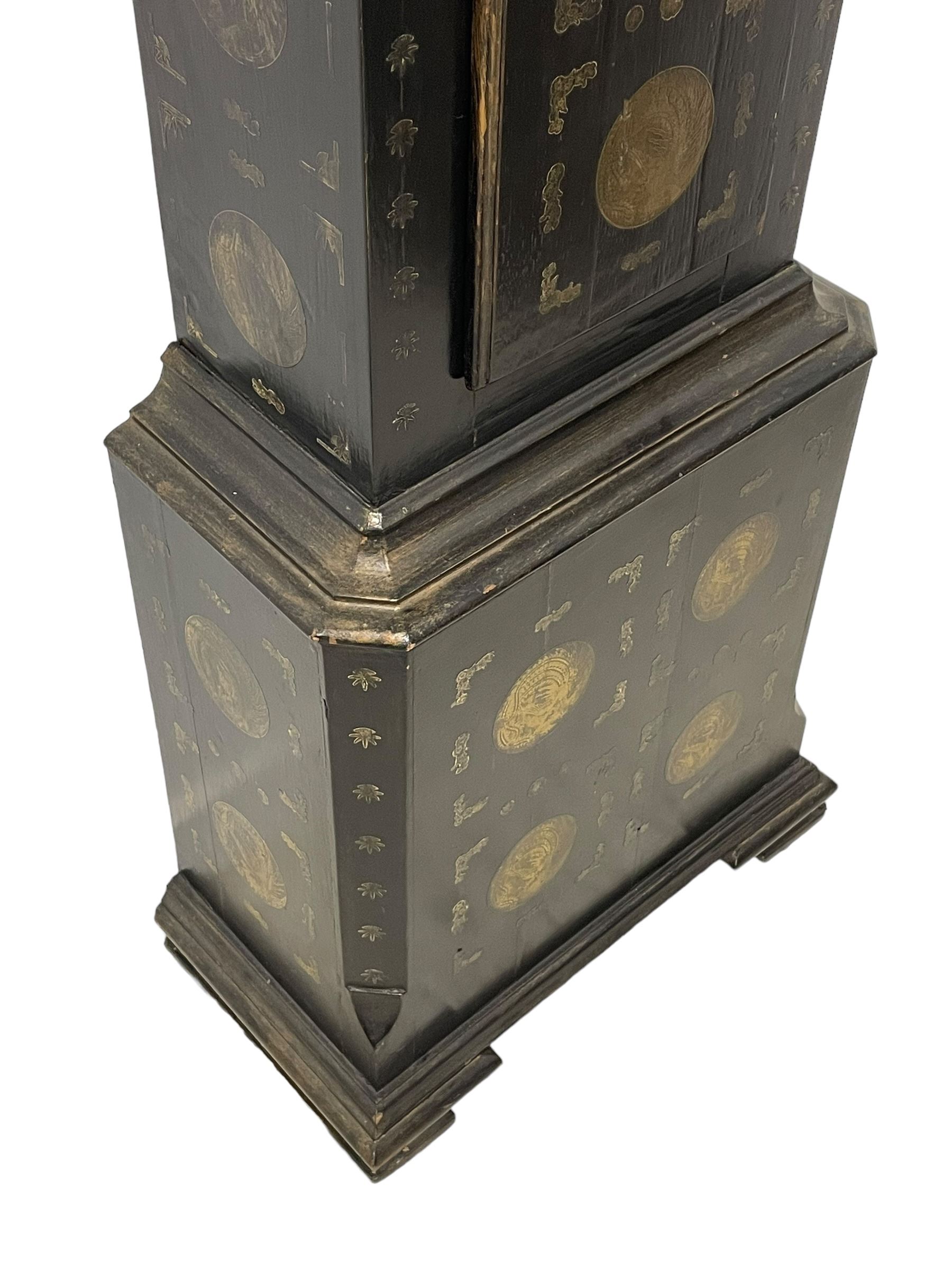 James Bowra of Sevenoaks Kent - 18th century 8-day ebonised longcase clock with gilt decoration c1740, with a flat top, dentil moulding beneath and shaped back splats, break arch hood door flanked by plain pilasters with wooden capitals, long trunk with a curved topped door, on a square plinth with canted corners and raised on a moulded base, brass dial with cast spandrels and a silvered 'Punch' automata to the arch, matted dial centre with seconds ring and date aperture, silvered chapter ring with Roman numerals, five minute Arabics, minute and quarter hour tracks, with matching steel hands and silvered makers name plate, rack striking movement with a recoil anchor escapement, striking the hours on a bell. With weights and pendulum.