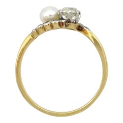 Early 20th century old cut diamond and pearl crossover ring, with diamond set scalloped design shoulders, stamped 18ct, principle diamond approx 0.35 carat