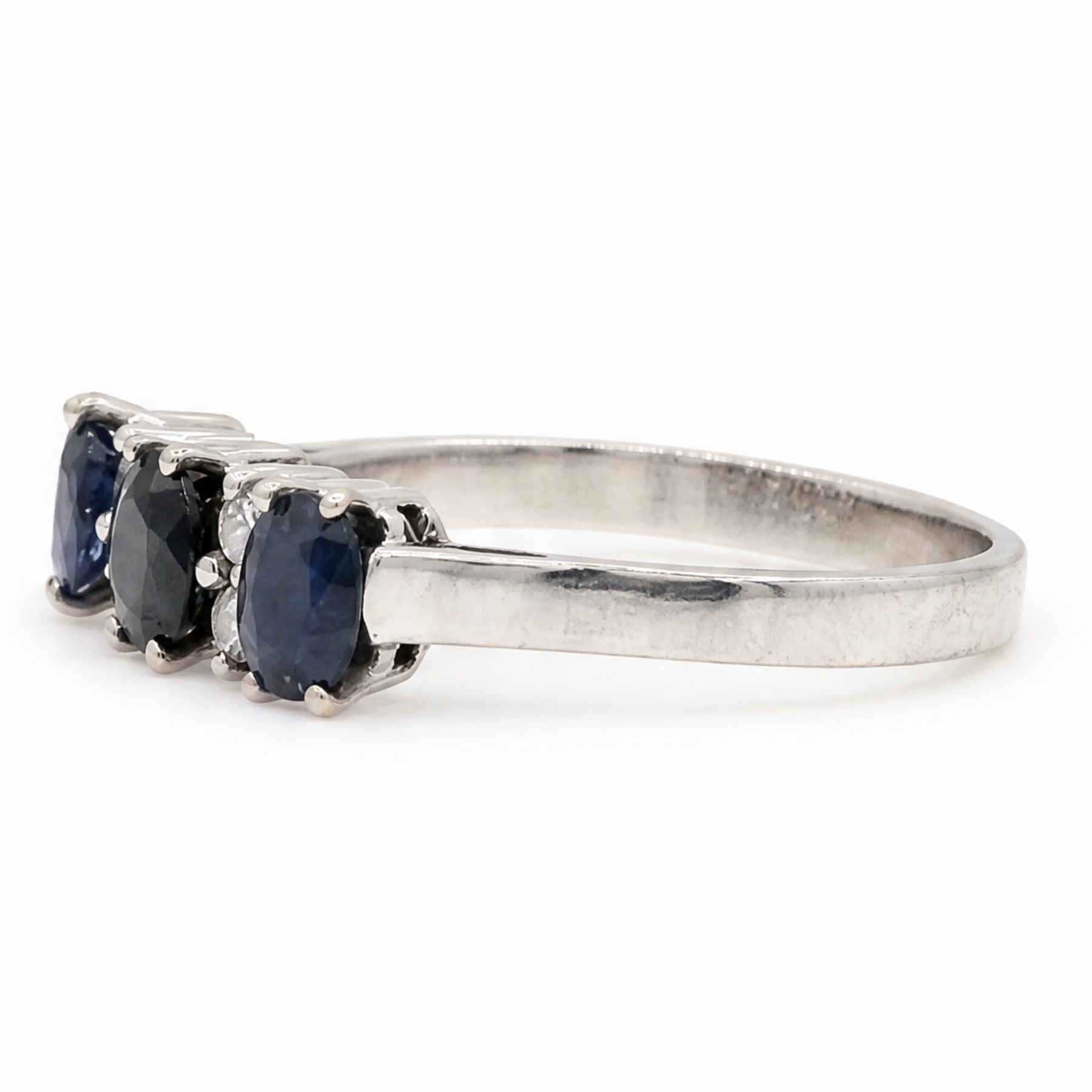 18ct white gold sapphire and diamond ring, three oval cut sapphires spaced by three round brilliant cut diamonds