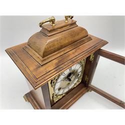 Late 20th century walnut cased bracket clock, sarcophagus top with loop handle, the brass dial with penny moon phase, Roman chapter ring and decorated with ornate cast metal spandrels, triple train driven movement by 'Franz Hermle', quarter chiming