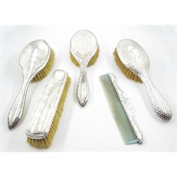 Group of five silver mounted dressing table brushes, comprising two early 20th century hair brushes, hallmarked Walker & Hall, Chester 1918, an Edwardian hair brush with planished finish, hallmarked William Adams Ltd, Birmingham 1901, an early 20th century clothes brush, and an early 20th century comb