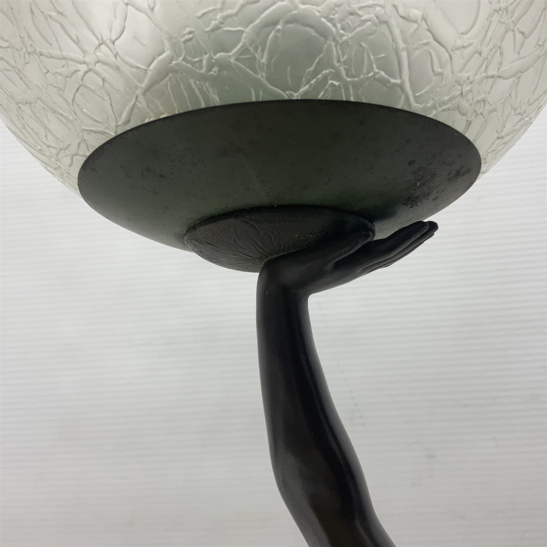 1930s Art Deco spelter table lamp, modelled as a nude woman holding aloft a spherical crizzled glass shade, upon a marble base, H48cm