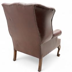 Georgian design leather wingback armchair, deep-buttoned burgundy leather upholstery with rolled arms, studded detail along the edges, raised on cabriole supports terminating in claw and ball feet
