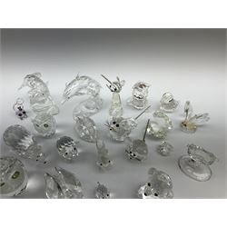 A collection of Swarovski Crystal Miniature Figures, comprising of two dolphins, two oyster shells, two owls, two mice, two pigs, two swans, a squirrel, a bear, a cat, etc, some in original boxes,  some damage but most  is in good condition