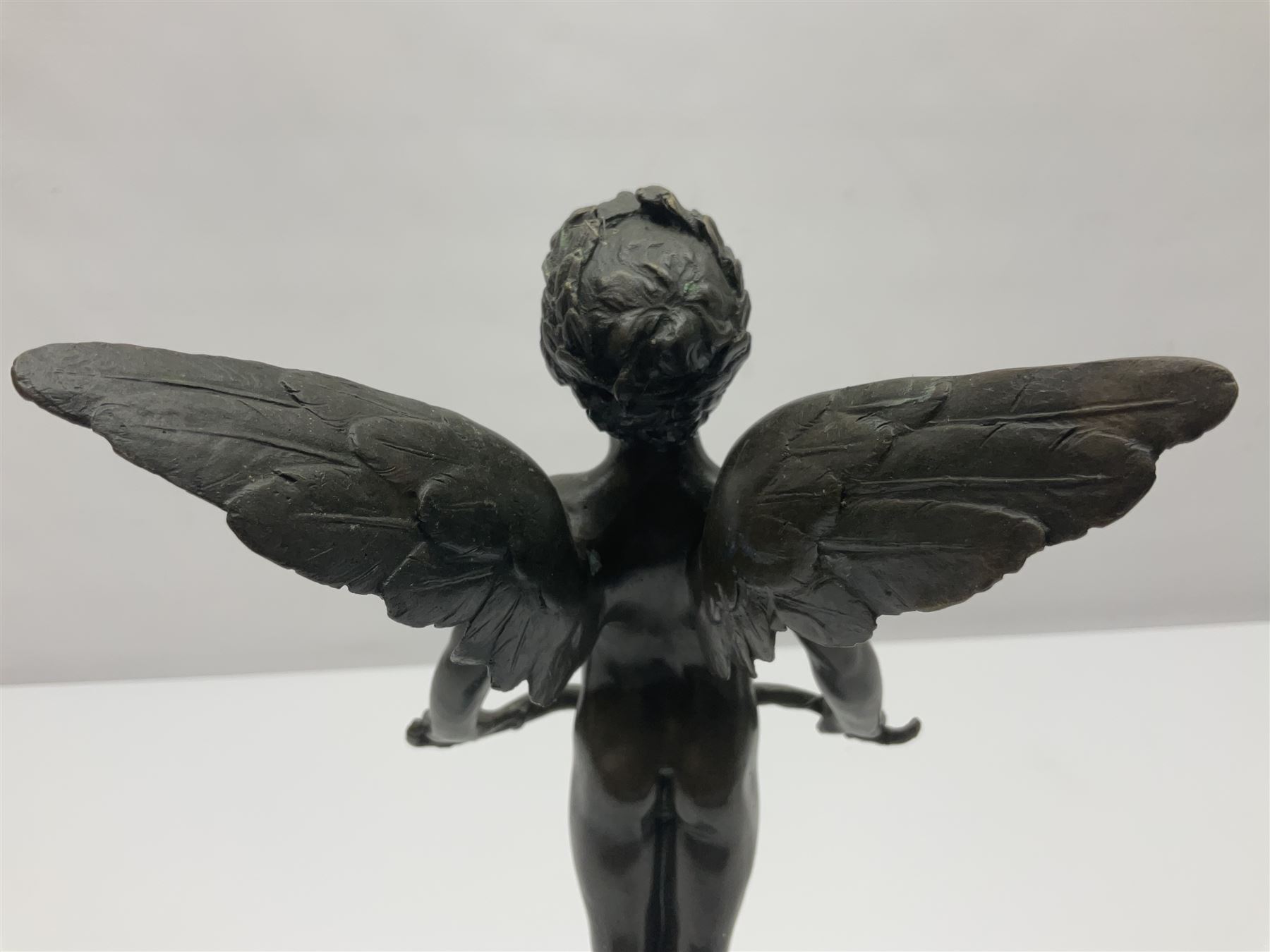 After Moreau, bronzed figure modeled as an angel holding a bow, with foundry mark upon socle base, H30cm