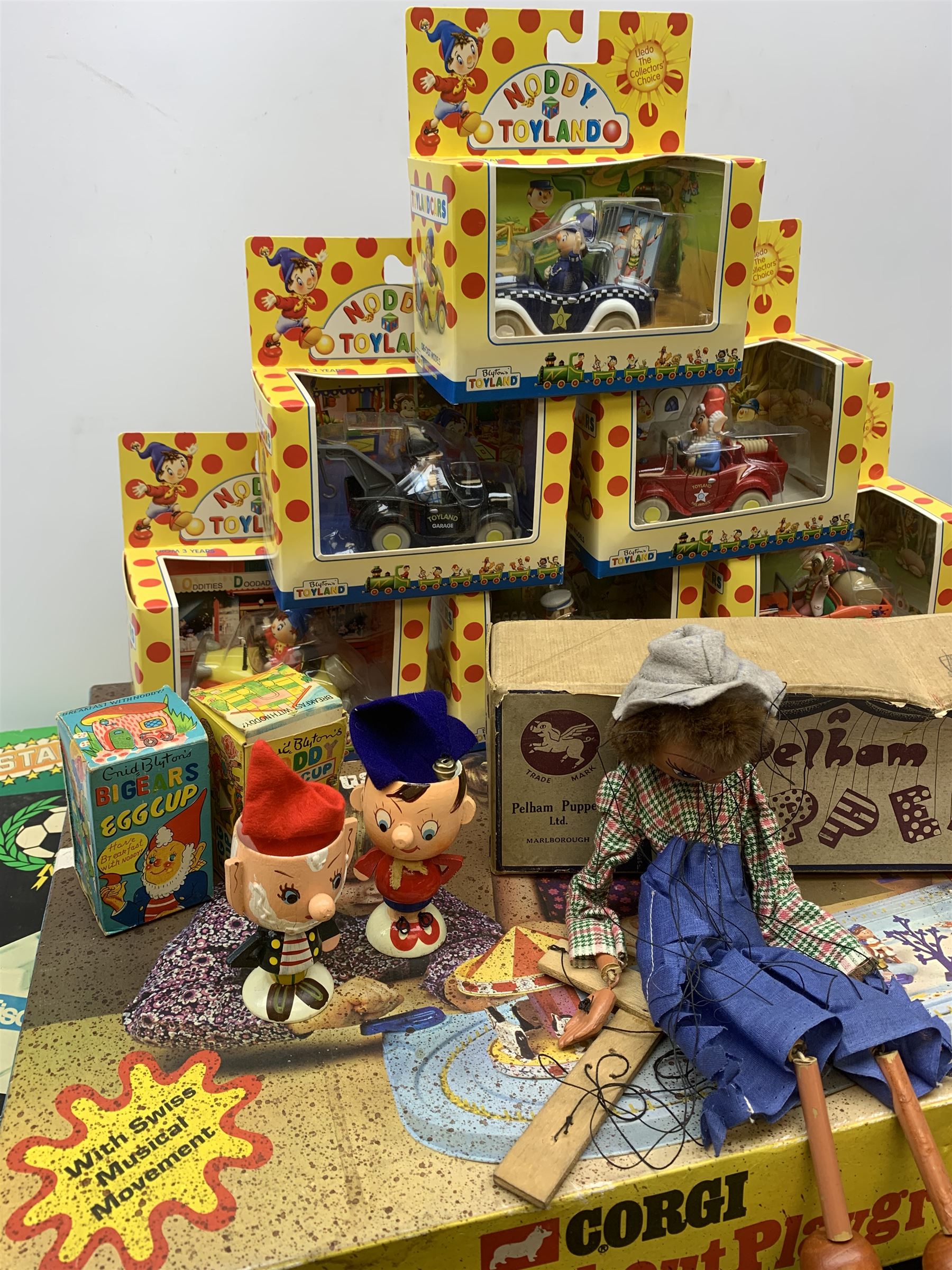 1970s Corgi Magic Roundabout Playground No.853; 1960s Bock Finland Pola600 table top football game; 1950s Pelham Puppet - Cowgirl; six Lledo Noddy in Toyland die-cast models; Good Soldiers set of five Noddy in Toyland cast metal figures; pair of Noddy and Big Ears painted wooden egg cups with hats; and DC Bronze Age Collection pair of Batmobiles; all boxed (13)
