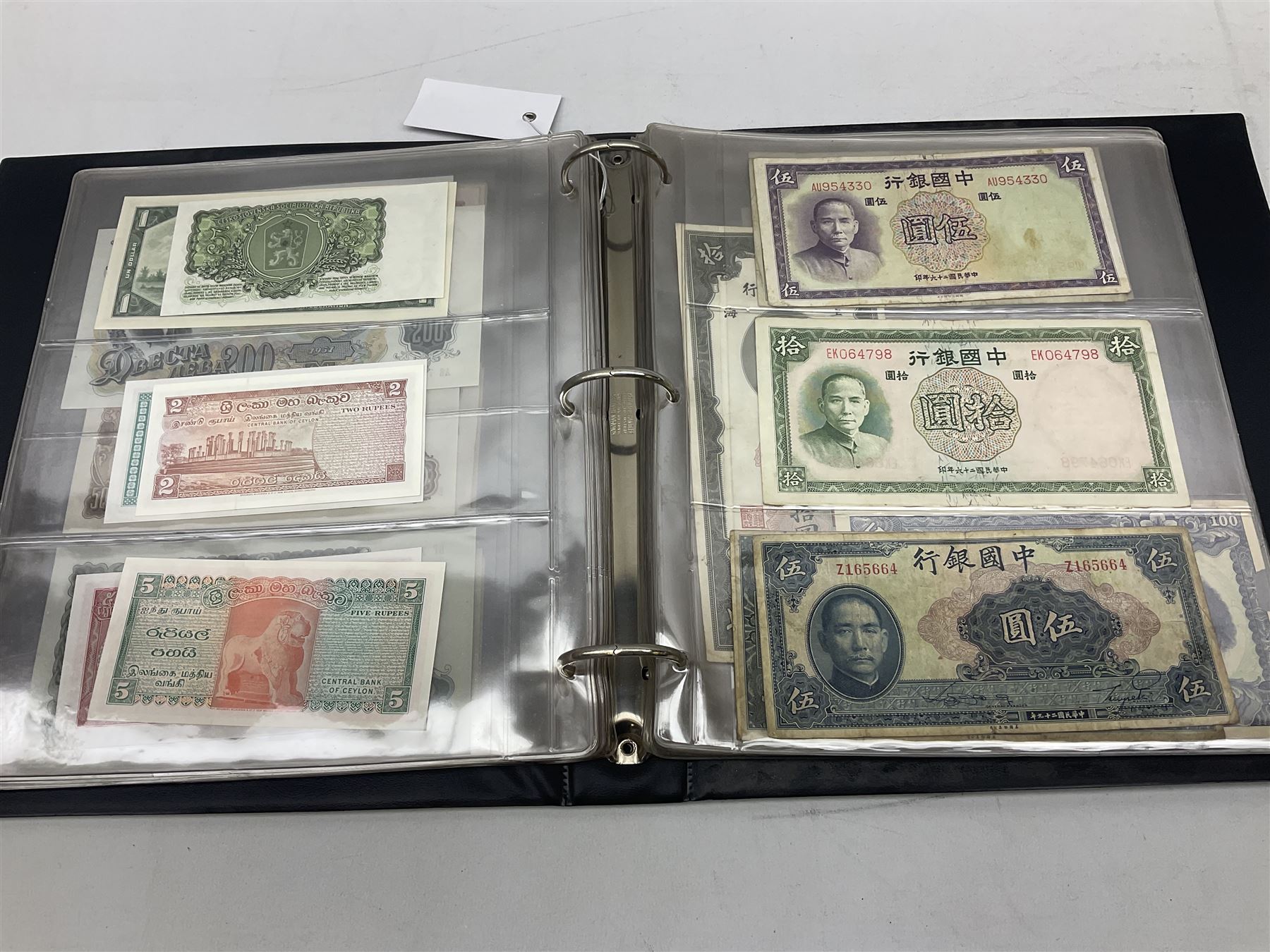 World banknotes, including Queen Elizabeth II The States of Jersey one pound 'DB202703', five pounds 'BB527762' and ten pounds 'AB651481', reserve bank of New Zealand two dollars '1L3 741894', King George V Straits Settlements one dollar 1st January 1935 'F/83 28924', various Bank of England notes etc, housed in two ring binder albums