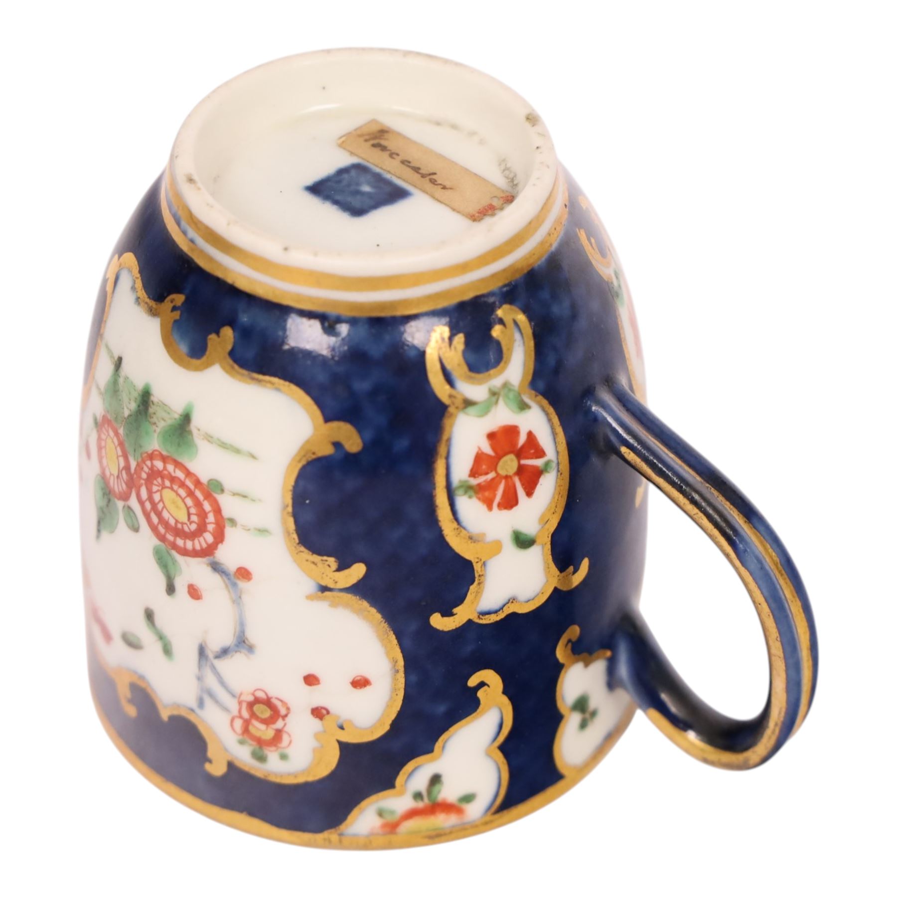 18th century Worcester coffee cup and saucer, circa 1770,  painted with shaped panels of chrysanthemums and banded hedges on a blue scale ground with gilt detail to the rim, mark beneath, H8cm 