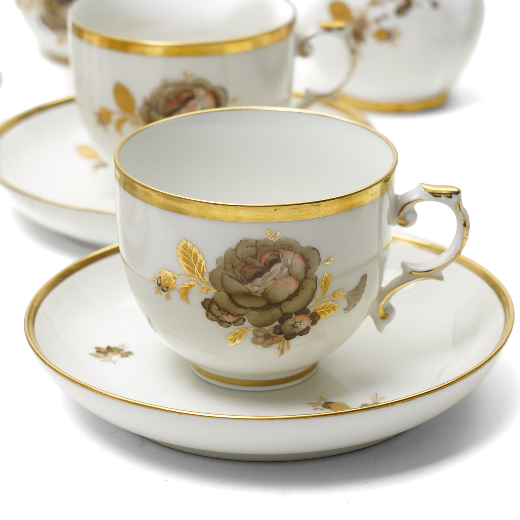 Furstenberg tea service decorated with sprays of flowers within a gilt rim comprising twelve cups and saucers, twelve plates, tea pot, hot water jug, milk jug, sugar bowl and cover and cake plate