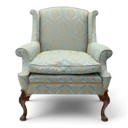 Georgian design carved mahogany framed wingback armchair, high wingback over sprung seat and loose cushion with rolled arms, upholstered in cyan ground gilt foliate damask fabric, on shell-carved cabriole supports with pad feet