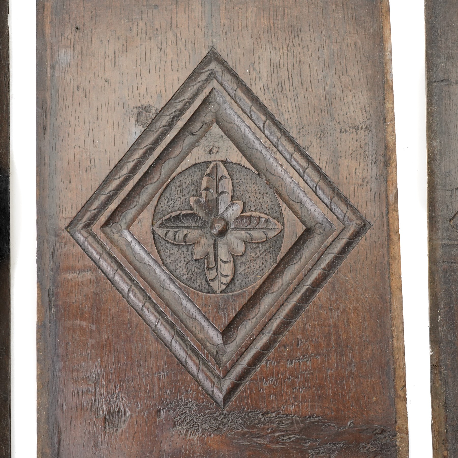 Set of four 17th century carved panels with lozenge decoration, and three further carved panels, lozenge panels approx 36.5cm x 24cm, three further 35cm x 10cm 