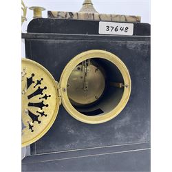 Late 19th century French mantle clock with a Parisian single train eight-day timepiece movement, enamel dial with roman numerals, minute markers and steel moon hands, brass bezel with gilt egg and dart slip, pendulum regulation arbor, Belgium slate case with inlaid panels of contrasting white and black veined marble, incised decoration to the plinth and pediment, grotesque masks to the sides, with a stepped plinth raised on four paw feet, pediment surmounted by a gilt and marble ornamentation on a foliated circular base with crocket finial, pair of candelabras in matching form with four scrolling branches and lights centred by a fifth.
With key and pendulum. 
